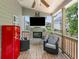 Covered patio featuring a charming brick fireplace, outdoor seating and a vintage refrigerator at 33 New Kent Ct, Villa Rica, GA 30180