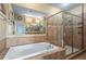 Bathroom features soaking tub, glass shower, and tiled walls at 3820 Roswell Ne Rd # 1001, Atlanta, GA 30342