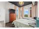 Bright bedroom with hardwood floors, city views, and a dresser at 3820 Roswell Ne Rd # 1001, Atlanta, GA 30342