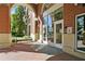 Inviting entrance with brick accents, large windows, and a cozy bench for residents and guests at 3820 Roswell Ne Rd # 1001, Atlanta, GA 30342