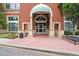 Grand entrance with brick facade, elegant columns, and a welcoming awning for The View @ Chastain at 3820 Roswell Ne Rd # 1001, Atlanta, GA 30342