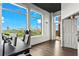 Bright home office with hardwood floors, a large window overlooking the city, and a balcony access door at 3820 Roswell Ne Rd # 1001, Atlanta, GA 30342