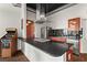 Modern kitchen with stainless steel appliances, dark countertops, tile backsplash, and a retro arcade game at 3820 Roswell Ne Rd # 1001, Atlanta, GA 30342