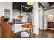 Open-concept kitchen and dining area with an arcade game, a breakfast table, and modern finishes at 3820 Roswell Ne Rd # 1001, Atlanta, GA 30342