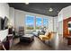Bright living room with hardwood floors, large windows boasting city views, and stylish contemporary furniture at 3820 Roswell Ne Rd # 1001, Atlanta, GA 30342