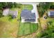 An aerial view of a modern home with a long driveway and large backyard at 1349 Oak Road, Lilburn, GA 30047