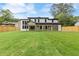 View of a modern white home with large windows and a covered patio at 1349 Oak Road, Lilburn, GA 30047