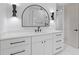 Bathroom vanity with white countertop, black fixtures, modern lighting, and framed mirror at 1349 Oak Road, Lilburn, GA 30047