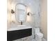 Modern bathroom with marble walls, a vessel sink, and contemporary fixtures at 1349 Oak Road, Lilburn, GA 30047