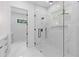 Bathroom featuring a luxurious glass shower with marble tile and modern fixtures, and view to the vanity area at 1349 Oak Road, Lilburn, GA 30047