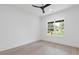 Bright bedroom featuring hardwood flooring, a modern ceiling fan, and a large window at 1349 Oak Road, Lilburn, GA 30047