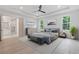 Staged bedroom highlighting a tray ceiling, ensuite bath access and hardwood floors at 1349 Oak Road, Lilburn, GA 30047