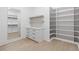 Walk-in closet with custom shelving, drawers, and a full-length mirror, providing ample storage and organization at 1349 Oak Road, Lilburn, GA 30047