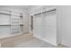 A walk-in closet with white built-in shelving and drawers to maximize storage at 1349 Oak Road, Lilburn, GA 30047