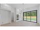 Bright dining room with hardwood floors, modern light fixture, and sliding glass doors at 1349 Oak Road, Lilburn, GA 30047