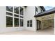 The exterior back of the home featuring many windows and a covered patio at 1349 Oak Road, Lilburn, GA 30047