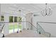 Bright foyer featuring high ceilings, a modern chandelier, glass railings, and a view of the backyard at 1349 Oak Road, Lilburn, GA 30047