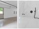 Convenient garage dog wash with a modern shower wand and marble tile at 1349 Oak Road, Lilburn, GA 30047