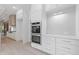 Modern kitchen features white cabinets, stainless steel appliances, and a double oven at 1349 Oak Road, Lilburn, GA 30047