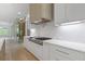 A gourmet kitchen features white cabinetry, a professional range, and a wine storage area at 1349 Oak Road, Lilburn, GA 30047
