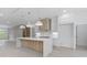 Modern kitchen with large island, pendant lighting, white cabinets, and stainless appliances at 1349 Oak Road, Lilburn, GA 30047