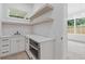 Kitchenette with light countertops, floating shelves and built-in appliances at 1349 Oak Road, Lilburn, GA 30047