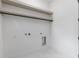 Practical laundry room featuring floating shelves, a hanging rod, and connections for washer and dryer at 1349 Oak Road, Lilburn, GA 30047