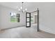 Open living room featuring hardwood floors and modern black framed windows at 1349 Oak Road, Lilburn, GA 30047