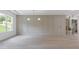 Living room with paneled accent wall, hardwood floors and lots of natural light at 1349 Oak Road, Lilburn, GA 30047