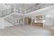 Spacious living area with a grand staircase, high ceilings, and an open-concept kitchen at 1349 Oak Road, Lilburn, GA 30047