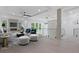 Bright living room featuring hardwood flooring, fireplace, modern lighting, blue chairs and white stools at 1349 Oak Road, Lilburn, GA 30047