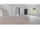 Bright, open living room featuring hardwood floors, recessed lighting, and a modern staircase at 1349 Oak Road, Lilburn, GA 30047