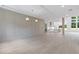 Bright, open-concept living space with hardwood floors and modern lighting, leading into the kitchen at 1349 Oak Road, Lilburn, GA 30047