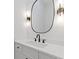 Powder room featuring a floating vanity, black fixtures, and modern light sconces at 1349 Oak Road, Lilburn, GA 30047