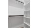 Bright walk-in closet with black racks and white built-in shelving for optimal organization at 1349 Oak Road, Lilburn, GA 30047