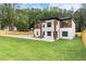 Spacious yard showcasing a modern two-story home with a well-manicured lawn and privacy fence at 1349 Oak Road, Lilburn, GA 30047