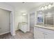 A spacious bathroom features dual vanities, wood-look floors, and a walk-in shower at 1462 Stephens View Dr, Loganville, GA 30052