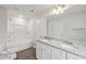 A bright bathroom features dual sinks, granite countertops, and a shower/tub combination at 1462 Stephens View Dr, Loganville, GA 30052