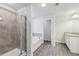 A bright bathroom features a tiled shower, separate tub, granite countertops, and wood-look floors at 1462 Stephens View Dr, Loganville, GA 30052