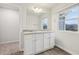 Bathroom featuring double sinks, light countertops and wood flooring at 1462 Stephens View Dr, Loganville, GA 30052