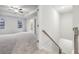 Spacious bedroom featuring tray ceiling, ceiling fan, carpet and adjoining bathroom at 1462 Stephens View Dr, Loganville, GA 30052