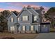 Charming two-story home with a manicured lawn and a two-car garage at 1462 Stephens View Dr, Loganville, GA 30052
