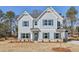 Charming two-story home with blue shutters and landscaped front yard, ready for new owners at 1462 Stephens View Dr, Loganville, GA 30052