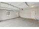 Spacious two car garage with windows, white walls, and access door at 1462 Stephens View Dr, Loganville, GA 30052