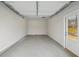 Clean single car garage with white door and concrete floor at 1462 Stephens View Dr, Loganville, GA 30052