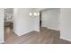 Hallway leading to a dining room, with a view of a stylish kitchen featuring stainless steel appliances at 1462 Stephens View Dr, Loganville, GA 30052