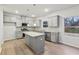 Charming kitchen featuring gray cabinets, stainless steel appliances, granite countertops and a kitchen island at 1462 Stephens View Dr, Loganville, GA 30052