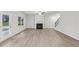 Spacious living room featuring fireplace, ceiling fan, and wood-look flooring for comfortable living at 1462 Stephens View Dr, Loganville, GA 30052