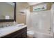 Well-lit bathroom with vanity, framed mirror, and shower with bathtub showcasing modern fixtures at 523 Huntgate Rd, Woodstock, GA 30189