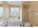 Bathroom with a large soaking tub, separate glass-enclosed shower, and vanity at 523 Huntgate Rd, Woodstock, GA 30189